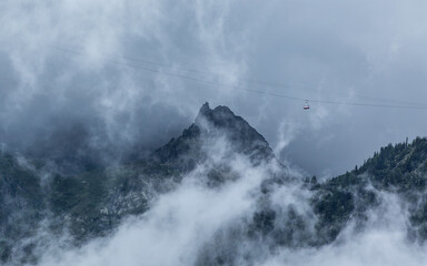 Alps, mist and gondola