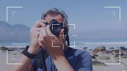 Camera user interface frame and focus screen over caucasian senior man by the sea taking photos - Powered by Adobe