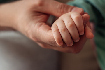 Baby's palm in the father's hand.Father's Day concept.Close-up,selective focus.