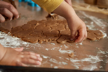 Mother's Day concept. Father and son together bakes cookies at home. Homemade baking. Present for Mom for Mother's Day. High quality photo