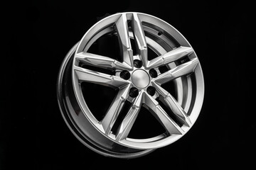 silver new alloy wheel with bifurcated beams on a black background
