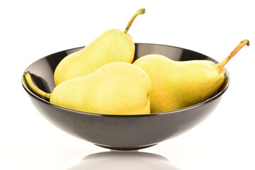 Several ripe yellow pears in a black ceramic plate, close-up, isolated on white.