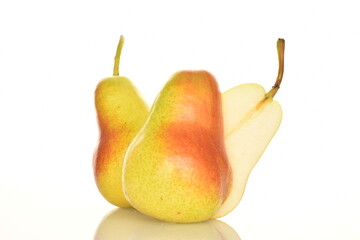 One half and two whole organic ripe, yellow pears, close-up, isolated on white.