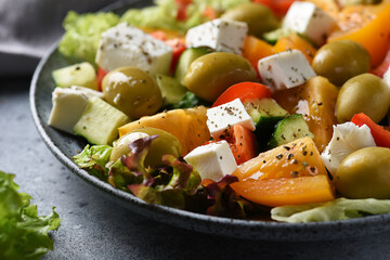 Fresh vegetable salad with olives and feta for lunch in a beautiful plate

