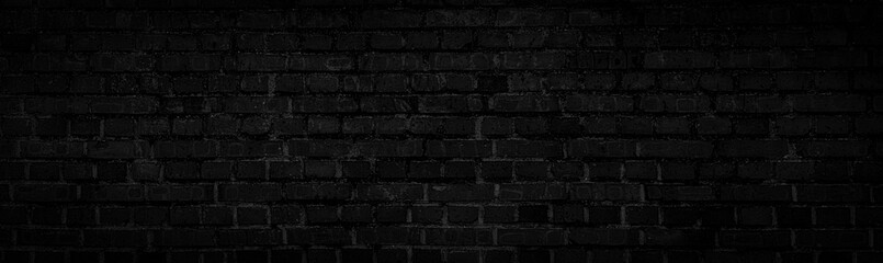 Dark, broken, rough-textured black brick background.