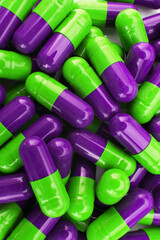 Pile of green and purple capsual pills