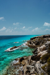 Fototapeta na wymiar Isla Mujeres, Mexico cliff and water with blue colours. Sunny weather.