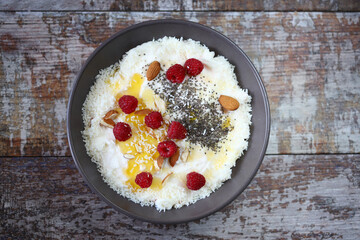 Selective focus. Coconut chia yogurt bowl with honey and berries.