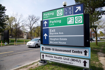 Sign on the road for direction to Sunnybrook's Mobile Health Unit (MHU)