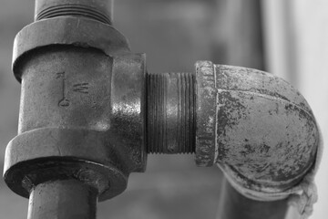 Black and white monochrome of a vintage iron water pipe