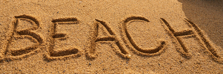 beach written on the sand of the beach