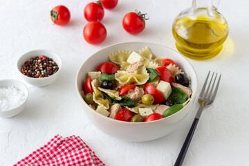 Pasta salad with tuna, tomatoes and white cheese. Farfalle. Healthy eating. Diet.