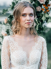 lovely beautiful young slender bride in an airy elegant white wedding dress with lace smile gentle portrait 