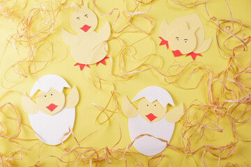 Children's paper craft. Handmade chickens on bright background