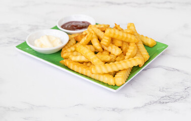 Fried french potatoes on marble table background, Tasty french fries on marble background. Selective focus