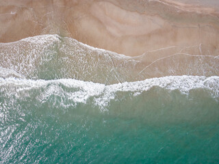 Fototapeta na wymiar Drone View of Waves Crashing Ashore in Atlantic Beach, North Carolina