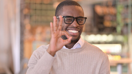 Portrait of Young African Man showing Ok Sign 
