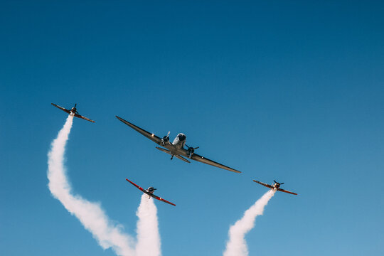 Vintage biplane does loop stunt with smoke trails. airplane air show - Powered by Adobe