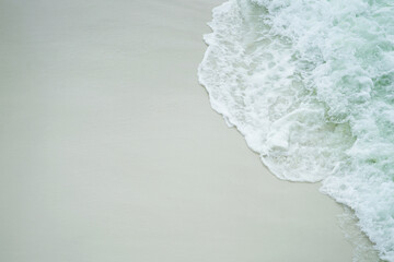 Turquoise Close up of a wave covering the white sand beach of Navarre, Florida, in Gulf of Mexico