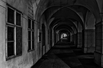 ancient arcade in the center of Prague in black and white at night illuminated by street lights