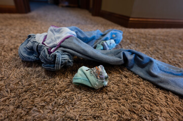 inside out reversed dirty cloths from a child tossed on the floor