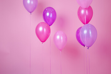 floating Colorful pink party balloons on pink pastel background. Space for text. Minimal idea creative concept of happiness, joy, birthday. holiday web banner with copy space