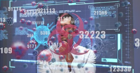 Animation of screen with biohazard sign, covid 19 cell and medical data processing over male doctor