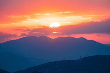 Fototapeta na wymiar Orange Sky and Purple mountains during a Sunset in Athens, Greece