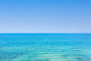 Fototapeta na wymiar Crystal clear ocean water with blue sky, Aerial image.