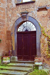 Fototapeta na wymiar old door in the medieval village of Civita di Bagnoregio in Viterbo, Italy