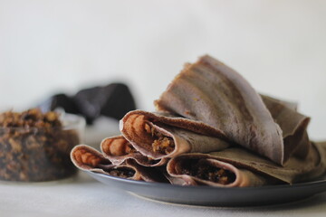 Finger millet crepes with freshly grated coconut and palm jaggery filling