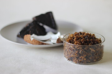 Grated coconut and palm jaggery mix prepared as a filling for finger millet crepes.