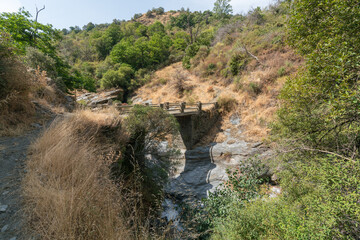 Fototapeta na wymiar bridge crossing a river in Sierra Nevada