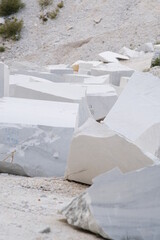 Blocks of white Carrara marble deposited in a square near the quarries.The marble is extracted from the mountains with cuts made with diamond wire.
 Alpi Apuane, Italy.