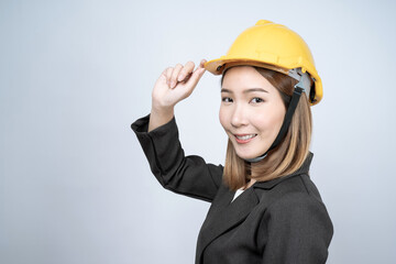 Asian female engineer in a black suit, isolated on a white background.