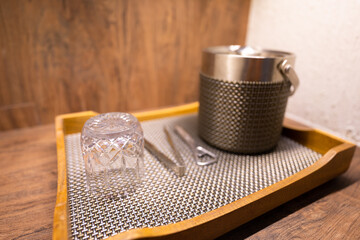 A set of whiskey or brandy drinking utensils such as glass, cooler box, bottle opener and ice tong...