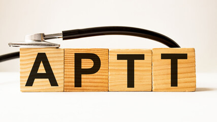 word APTT on wooden blocks. medical concept . the medicine