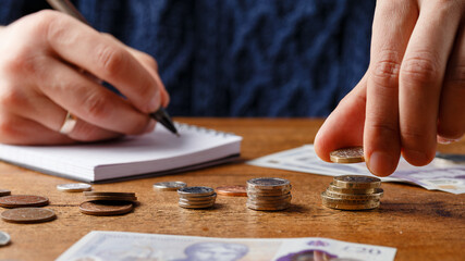 man counting monthly expenses, bills, money and payments doing paperwork, finance concept, Devon,...