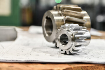 A cogwheel made on a gear cutting machine lies on the technical