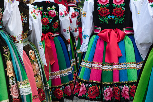 Women dressed in polish national folk costumes from Lowicz during annual Corpus Christi procession. Close up of traditional colorful folk skirts