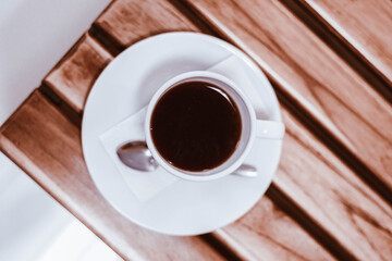 cup of coffee on wooden table