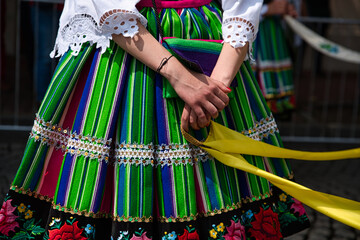 Woman dressed in polish national folk costumes from Lowicz region. Close up of traditional colorful...
