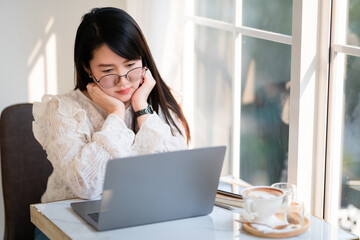 Happy of beautiful asian freelance people business female casual working with laptop computer with coffee cup and smartphone in coffee shop like the background,communication concept