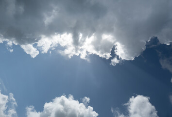 Ouffy white clouds with blue sky and sunrays