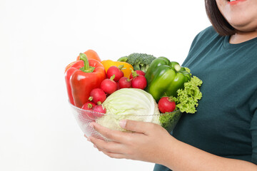 Fat Asian woman holding a bowl of fresh organic vegetables Food for good health. The concept of losing weight, reducing fat Healthy eating, nutrition, prescription food. White background