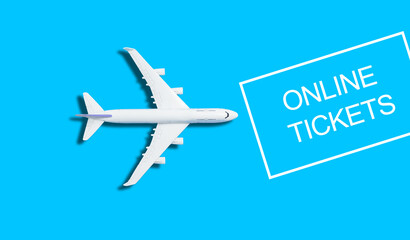 Flat lay design of travel concept with plane on blue and yellow background with copy space