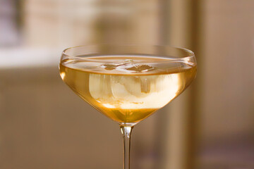 Cocktail glass with yellow drink. image. Close up image with shallow depth of field.
