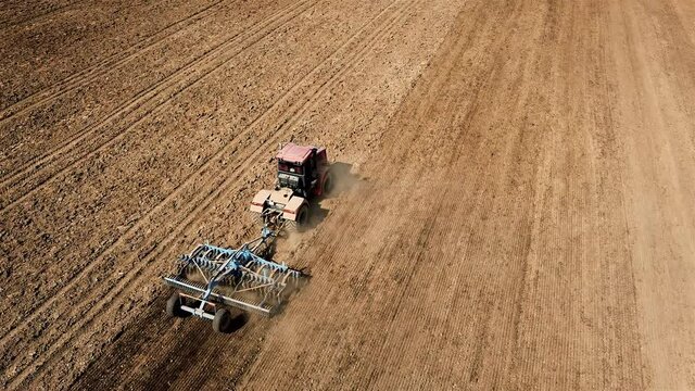 farm tractor stubble cultivation and mulching preparation aerial video