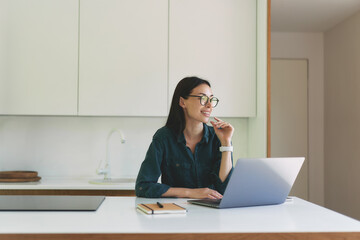 Front view of business woman working from home with laptop and notebook