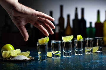 Shots of tequila with salt and lime.